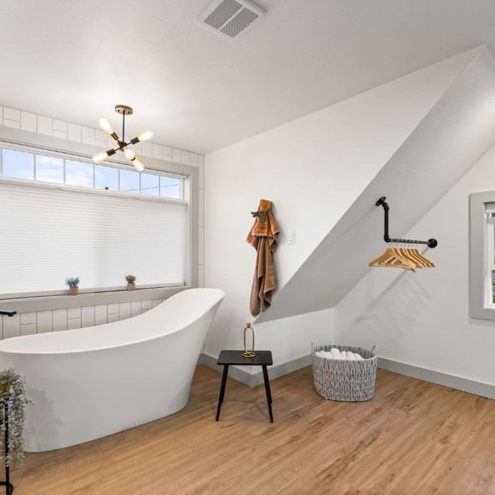 freestanding tub upstairs in master bedroom/bathroom with toilet room isolated on other side of the room.