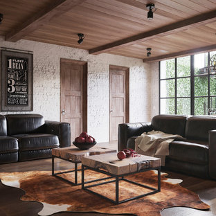 Large contemporary open plan home cinema in Barcelona with white walls, ceramic flooring, a wall mounted tv and brown floors.
