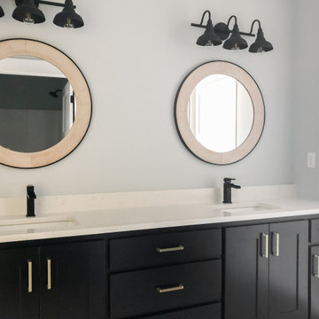 Double bathroom vanity with individual vanity lighting and mirror