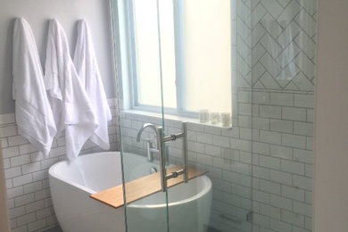 Example of a mid-sized classic master white tile and subway tile concrete floor and gray floor bathroom design in Detroit with beaded inset cabinets, white cabinets, gray walls, an undermount sink, quartz countertops, a hinged shower door and white countertops