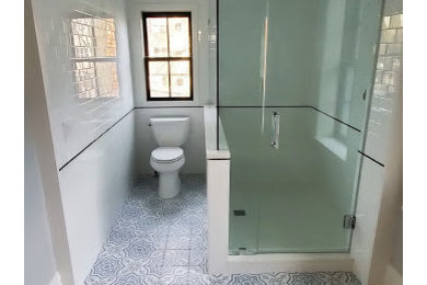 Mid-sized master white tile and subway tile cement tile floor and blue floor corner shower photo in Chicago with a two-piece toilet, white walls and a hinged shower door