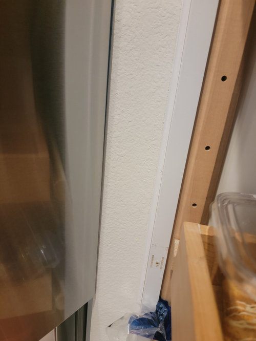Fridge door hitting drywall corner