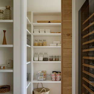 Inspiration for a scandinavian kitchen pantry in Other with open cabinets, white cabinets, medium hardwood floors and brown floor.
