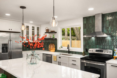 Mid-sized 1950s light wood floor and brown floor open concept kitchen photo in Seattle with an undermount sink, recessed-panel cabinets, green cabinets, quartz countertops, green backsplash, ceramic backsplash, stainless steel appliances, an island and white countertops