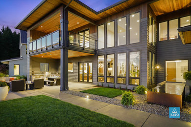 Inspiration for a small asian backyard concrete paver patio fountain remodel in Portland with a roof extension