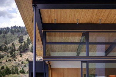Inspiration for a mid-sized modern one-story metal flat roof remodel in Los Angeles