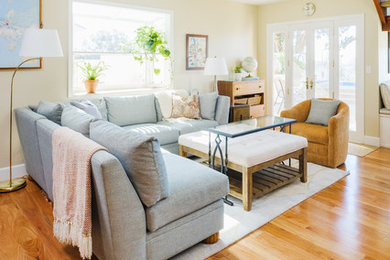 Family room - mid-sized coastal enclosed light wood floor and brown floor family room idea in San Diego with beige walls and no fireplace