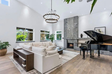 Living room - contemporary formal and open concept light wood floor living room idea in San Diego with white walls and a standard fireplace