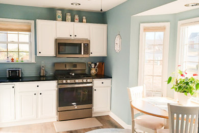Inspiration for a mid-sized farmhouse l-shaped eat-in kitchen remodel in DC Metro with raised-panel cabinets, white cabinets, quartz countertops and no island