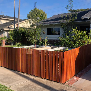 Stained picket fences are a beautiful way to accentuate an ornate garden.