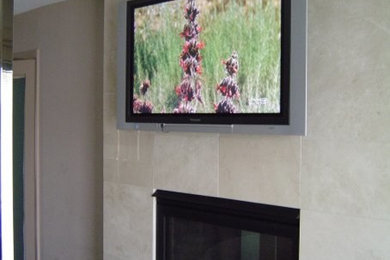 Example of a trendy family room design in Detroit with beige walls and a stone fireplace