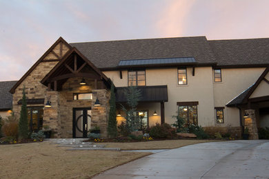 Inspiration for a large craftsman beige two-story stucco exterior home remodel in Oklahoma City with a tile roof