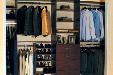 Inspiration for a large timeless men's medium tone wood floor walk-in closet remodel in New York with open cabinets and medium tone wood cabinets