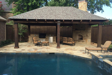 Inspiration for a mid-sized country backyard patio in Dallas with an outdoor kitchen, natural stone pavers and a gazebo/cabana.