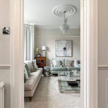 Calm & serene living room with a mix of chrome & brass metal accents