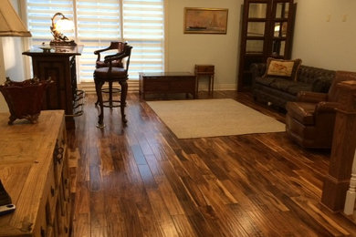 Large mountain style freestanding desk dark wood floor and brown floor study room photo in Other with beige walls