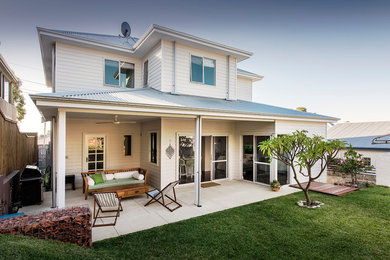 Beach style two-storey white house exterior in Perth with wood siding, a hip roof and a metal roof.