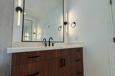 Bathroom - mid-sized scandinavian master beige tile and porcelain tile porcelain tile, beige floor and single-sink bathroom idea in Houston with flat-panel cabinets, dark wood cabinets, a one-piece toilet, beige walls, a drop-in sink, quartz countertops, a hinged shower door, white countertops and a floating vanity