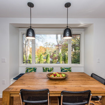 Modern hanging lights featured in both Kitchen and Dining room with an abundance
