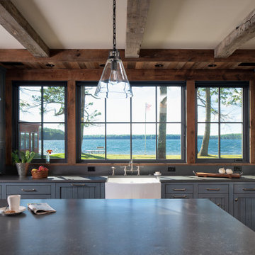 Reclaimed Wood Beams, Paneling, and Flooring in Rustic Cabin Kitchen