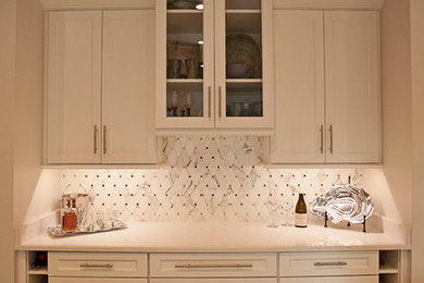 Inspiration for a mid-sized transitional single-wall porcelain tile home bar remodel in Other with no sink, recessed-panel cabinets, white cabinets, quartz countertops, white backsplash and marble backsplash