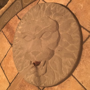 Inspiration for a mid-sized victorian backyard patio in Kansas City with a water feature.