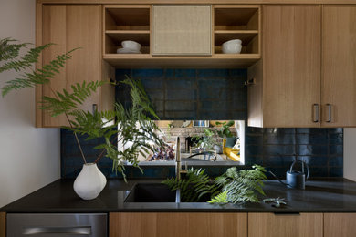 Inspiration for a 1950s gray floor and vaulted ceiling kitchen remodel in Seattle with light wood cabinets, blue backsplash, ceramic backsplash, stainless steel appliances, no island and gray countertops