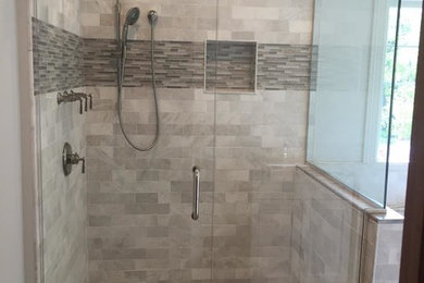 Example of a mid-sized minimalist master gray tile and stone tile pebble tile floor and gray floor double shower design in Chicago with white walls, granite countertops and a hinged shower door