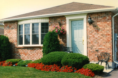 Inspiration for a brown one-story brick gable roof remodel in Toronto