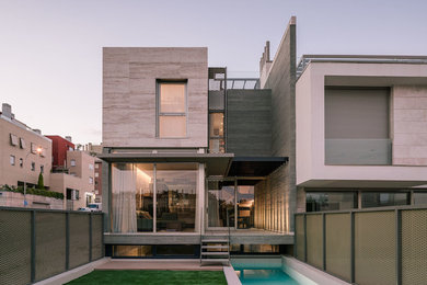 Inspiration for a mid-sized contemporary multicolored three-story stone exterior home remodel in Madrid with a tile roof