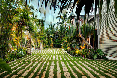 Mid-sized tropical front yard driveway in Tampa with natural stone pavers.