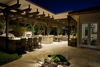 Mid-sized traditional backyard patio in Sacramento with an outdoor kitchen, tile and a pergola.