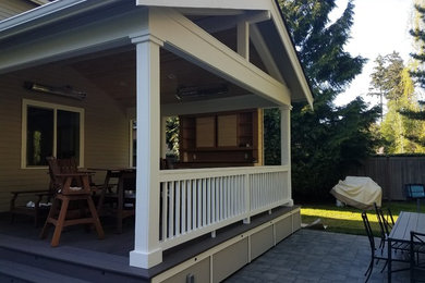 Large elegant backyard patio kitchen photo in Other with decking and a roof extension