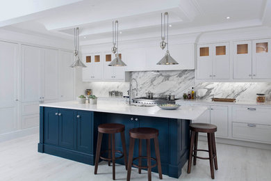 Medium sized classic l-shaped open plan kitchen in Other with a submerged sink, shaker cabinets, grey cabinets, quartz worktops, grey splashback, marble splashback, stainless steel appliances, light hardwood flooring, an island and white floors.