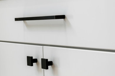 Huge minimalist eat-in kitchen photo in San Francisco with white cabinets, white backsplash and gray countertops