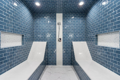 Photo of a large transitional master bathroom in Other with shaker cabinets, a two-piece toilet, white walls, porcelain floors, an undermount sink, granite benchtops, white floor, a hinged shower door, multi-coloured benchtops, a shower seat, a double vanity, a built-in vanity, white cabinets, blue tile and subway tile.
