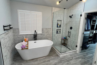 Inspiration for a mid-sized modern master gray tile and ceramic tile ceramic tile, gray floor, double-sink and vaulted ceiling bathroom remodel in Denver with shaker cabinets, white cabinets, a one-piece toilet, gray walls, an integrated sink, quartzite countertops, a hinged shower door, white countertops, a niche and a built-in vanity