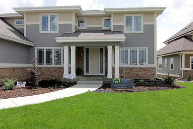 Large transitional blue two-story stucco gable roof idea in Other