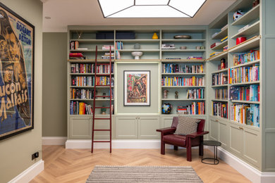 Medium sized classic foyer in London with green walls, light hardwood flooring, brown floors, a vaulted ceiling and feature lighting.