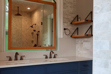 Double shower - mid-sized modern master beige tile double-sink double shower idea in Philadelphia with blue cabinets, beige walls, an undermount sink, a hinged shower door, white countertops and a built-in vanity