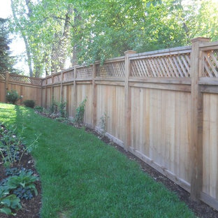 This is an example of a large traditional backyard full sun formal garden in Minneapolis with mulch.