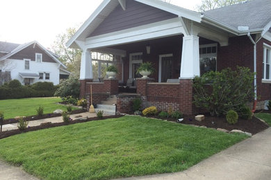 Mid-sized arts and crafts red two-story brick gable roof photo in Other