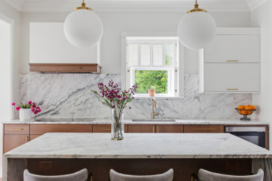 Inspiration for a large modern medium tone wood floor and brown floor eat-in kitchen remodel in Chicago with an undermount sink, flat-panel cabinets, medium tone wood cabinets, quartzite countertops, white backsplash, stainless steel appliances, an island and yellow countertops