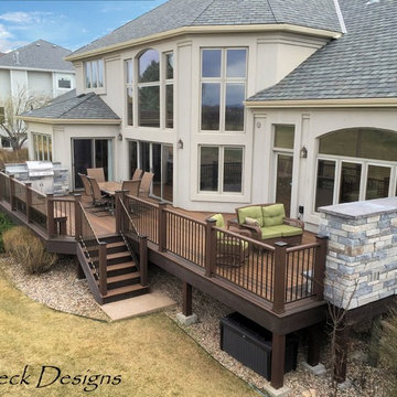 Large Evergrain Envisions deck with Fireplace and built in grill