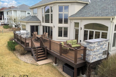 Large Evergrain Envisions deck with Fireplace and built in grill