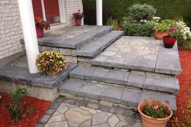 Inspiration for a mid-sized modern stone front porch remodel in Ottawa with a roof extension