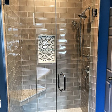 Frameless shower door, tiled shower with niche and bench