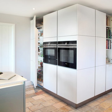 High gloss blue & matt white kitchen with tall storage units