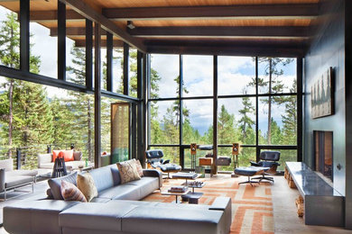 Living room - large rustic open concept light wood floor living room idea in Other with black walls, a stone fireplace and no tv