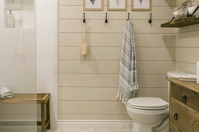 Mid-sized country master white tile and pebble tile pebble tile floor and beige floor bathroom photo in Tampa with medium tone wood cabinets, beige walls and a vessel sink